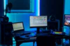 Studio with multiple monitors and big speakers in the dark